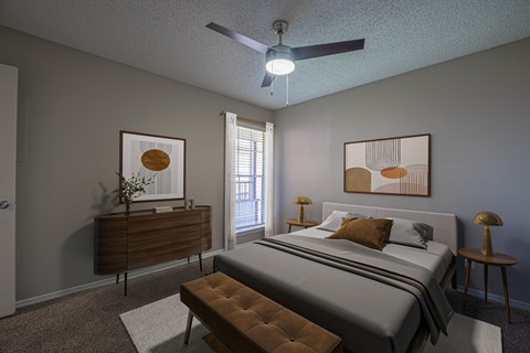 A bedroom with a bed, nightstand, and a ceiling fan.